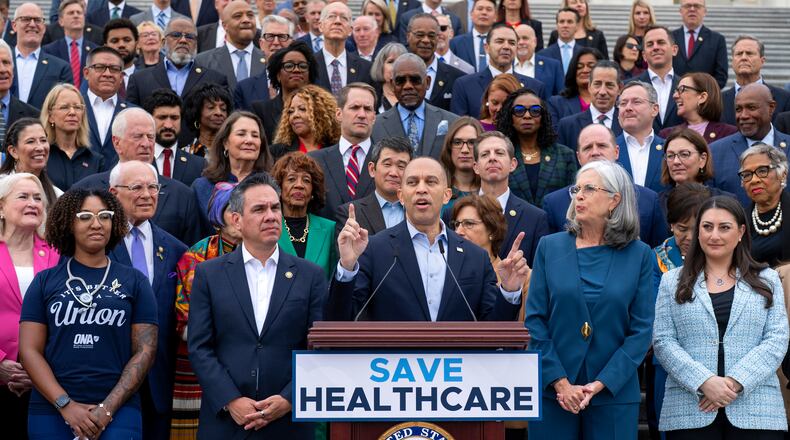House Minority Leader Hakeem Jeffries, D-N.Y. (center) flanked by colleagues and supporters, presses Democrats' case for extending health care subsidies at a news conference in Washington on Tuesday, Sept. 30, 2025. (J. Scott Applewhite/AP)