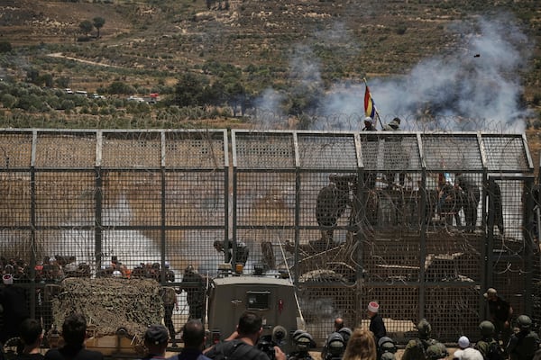 Syrian Druze protest near the Israeli-Syrian border, as seen from the town of Majdal Shams in the Israeli-controlled Golan Heights, Wednesday, July 16, 2025, amid the ongoing clashes between Syrian government forces and Druze armed groups in the southern Syrian city of Sweida. (AP Photo/Leo Correa)