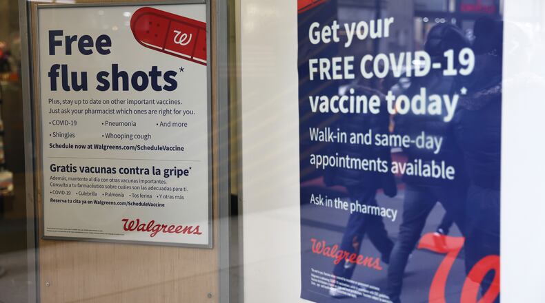 Flu and coronavirus (COVID-19) vaccine signage is seen at a Duane Reade by on Broadway on January 05, 2023 in New York City. (Michael M. Santiago/Getty Images/TNS)