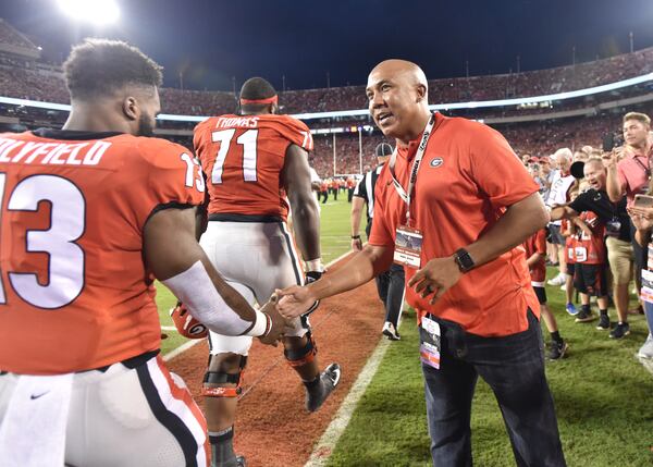 October 6, 2018 Athens - Former Georgia Bulldog Hines Ward greets Georgia running back Elijah Holyfield (13) before a NCAA college football game at Sanford Stadium in Athens on Saturday, October 6, 2018. HYOSUB SHIN / HSHIN@AJC.COM