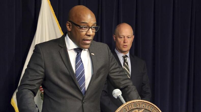 Illinois Attorney General Kwame Raoul (left) speaks at a news conference last month.