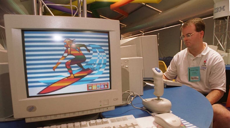 IBM employee Mike Underwood surfs on the internet in the "IBM Surf Shak" inside the Olympic Village in July 1996. The "Surf Shak" was designed to give athletes access to the internet and email, at a time when those technologies were still very new. (David Tulis / AJC file)