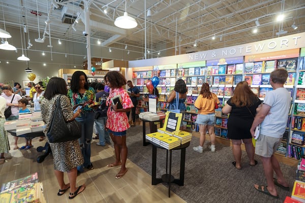 Customers wait in line to buy their items during the Barnes & Noble grand opening at the Edgewood Retail District on Moreland Avenue, Wednesday, July 8, 2026, in Atlanta. The Edgewood Barnes & Noble offers 15,000 square feet of books, toys, games, magazines, and more. It is in the former Office Depot space next to Kroger. (Jason Getz/AJC)