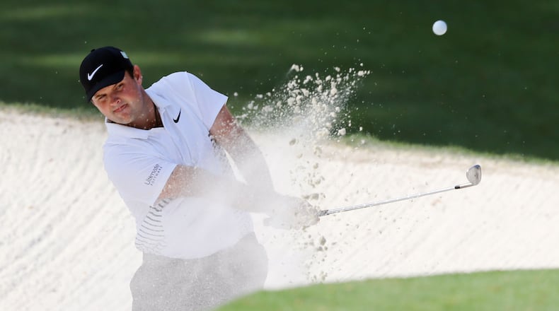 Patrick Reed finds a bit of trouble on No. 10 Friday, but it scarcely matters to the Masters leader. (Curtis Compton/ccompton@ajc.com)