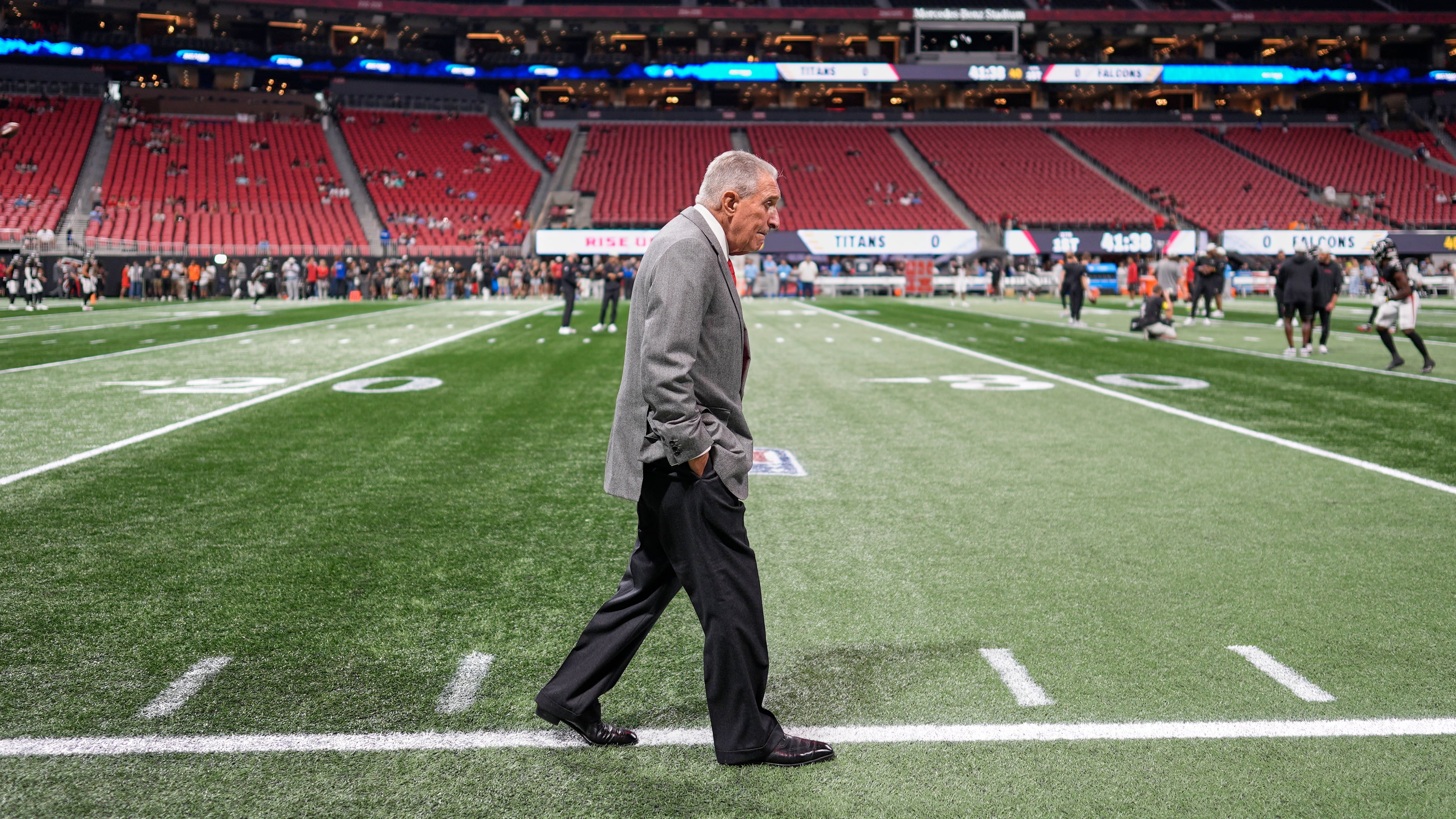 Atlanta Falcons owner Arthur Blank visits the sideline before a preseason NFL football game against the Tennessee Titans, Friday, Aug. 15, 2025, in Atlanta. (AP Photo/Mike Stewart)