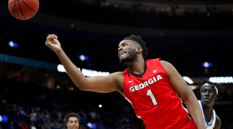 Georgia's Yante Maten (1) is unable to reach the ball before it goes out of bounds as Kentucky's Wenyen Gabriel, right, watches during the first half of an NCAA college basketball quarterfinal game at the Southeastern Conference tournament Friday, March 9, 2018, in St. Louis. (AP Photo/Jeff Roberson)