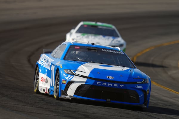 Denny Hamlin drives through Turn 3 during a NASCAR Cup Series auto race at Pocono Raceway, Sunday, June 22, 2025, in Long Pond, Pa. (AP Photo/Derik Hamilton)