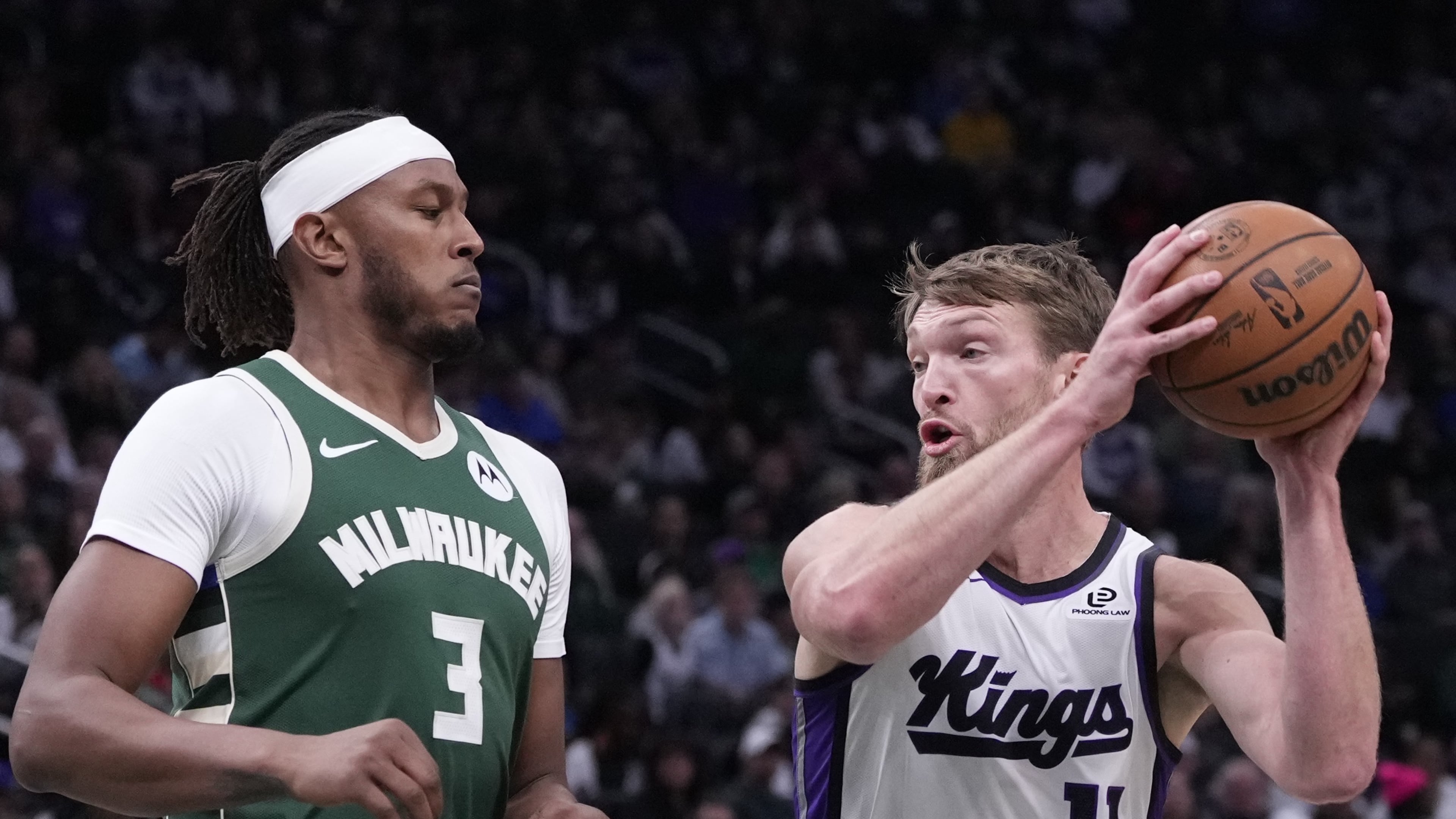 Sacramento Kings' Domantas Sabonis tries to get past Milwaukee Bucks' Myles Turner during the first half of an NBA basketball game Saturday, Nov. 1, 2025, in Milwaukee. (AP Photo/Morry Gash)
