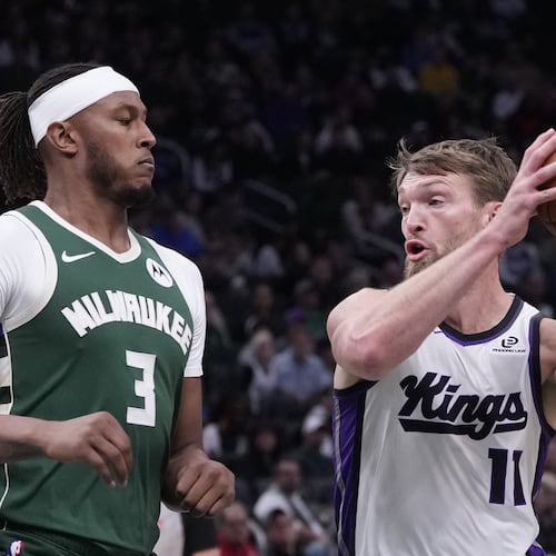 Sacramento Kings' Domantas Sabonis tries to get past Milwaukee Bucks' Myles Turner during the first half of an NBA basketball game Saturday, Nov. 1, 2025, in Milwaukee. (AP Photo/Morry Gash)