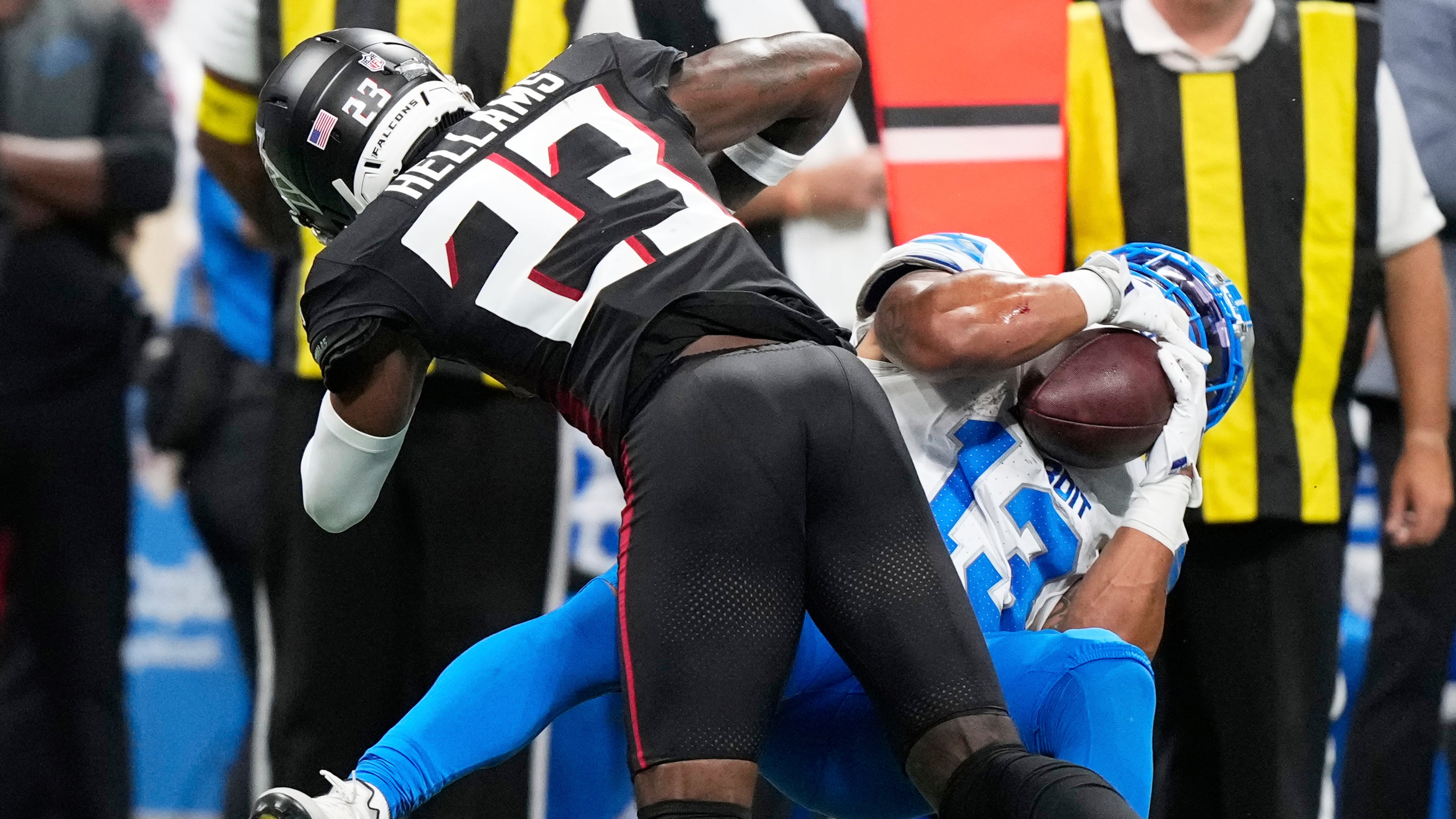 Falcons safety DeMarcco Hellams (left) hits Lions running back Craig Reynolds and breaks up a catch Friday, Aug. 8, 2025, in Atlanta. Hellams missed all of 2024 with a broken ankle and high ankle sprain. (Brynn Anderson/AP)