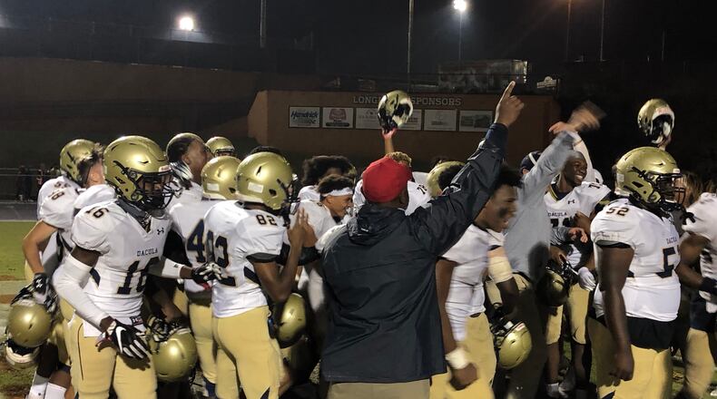Dacula football players celebrate their 28-27 win over rival Lanier.