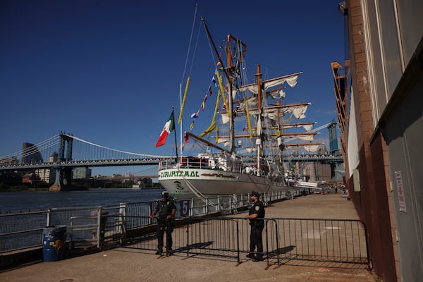 New York Police officers stands watch on Pier 35 where the Cuauhtémoc, a masted Mexican Navy training ship that collided with the Brooklyn Bridge the night before, sits docked. (AP Photo/Yuki Iwamura)