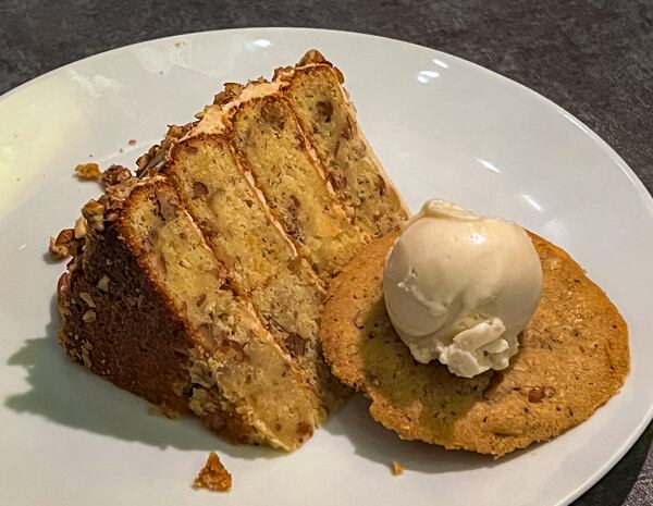 This dessert at Natalie Bianca provides a huge slice of decadent butter pecan cake with a pecan cookie and ice cream. (Henri Hollis/AJC)