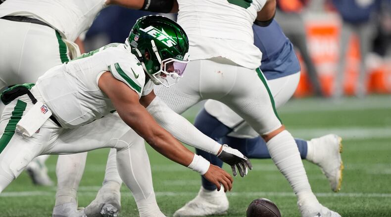 New York Jets quarterback Justin Fields fumbles the ball during the second half of an NFL football game against the New England Patriots, Thursday, Nov. 13, 2025, in Foxborough, Mass. (AP Photo/Robert F. Bukaty)
