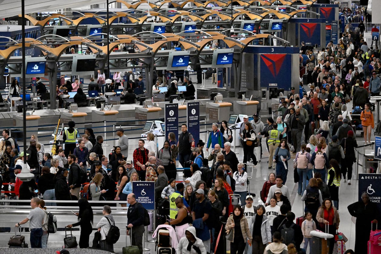 Early morning travelers waited in long lines from baggage claim area to get through the TSA security screening amid the partial government shutdown at Hartsfield-Jackson Atlanta International Airport, Saturday, March 21, 2026. (Hyosub Shin/AJC File)