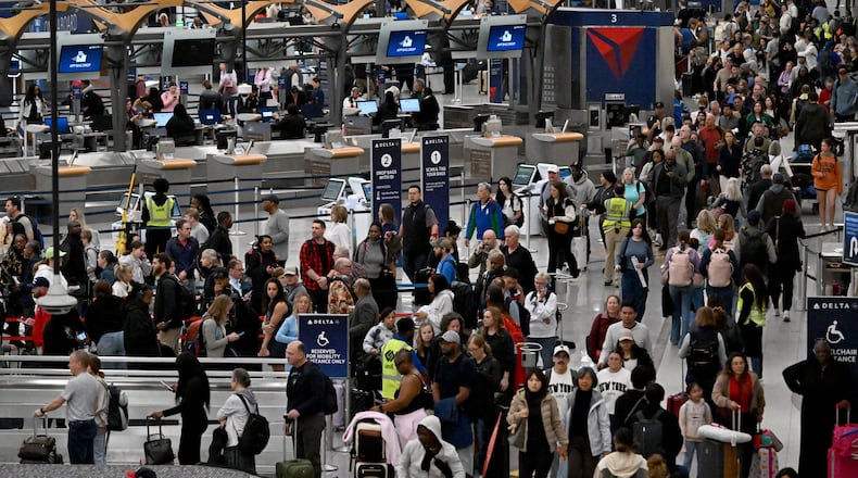 Early morning travelers waited in long lines from baggage claim area to get through the TSA security screening amid the partial government shutdown at Hartsfield-Jackson Atlanta International Airport, Saturday, March 21, 2026. (Hyosub Shin/AJC File)