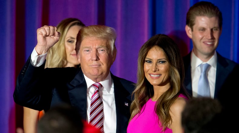 FILE - In this June 7, 2016 file photo, Republican presidential candidate Donald Trump gestures to supporters as he leaves the stage with his wife Melania after a news conference at the Trump National Golf Club Westchester in Briarcliff Manor, N.Y. Melania Trump insists she’s her own person, more than an accessory in her husband Donald Trump’s run for the White House. (AP Photo/Mary Altaffer)
