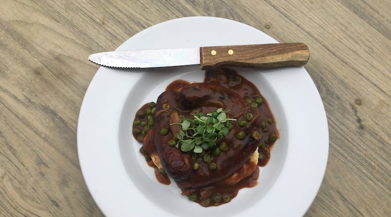 Executive chef Brian O’Rouke of Meehan’s Public House serves hearty grilled bangers and mash with English peas and gravy. PHOTO CREDIT: Meehan’s Public House