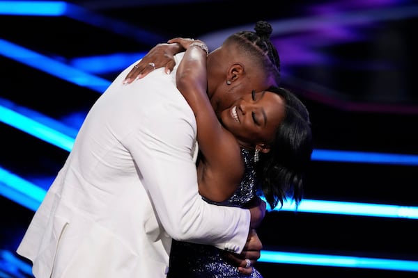 Simone Biles, right, hugs Jonathan Owens while accepting an award at the ESPY Awards at the Dolby Theatre in Los Angeles, Wednesday, July 16, 2025. (AP Photo/Mark J. Terrill)