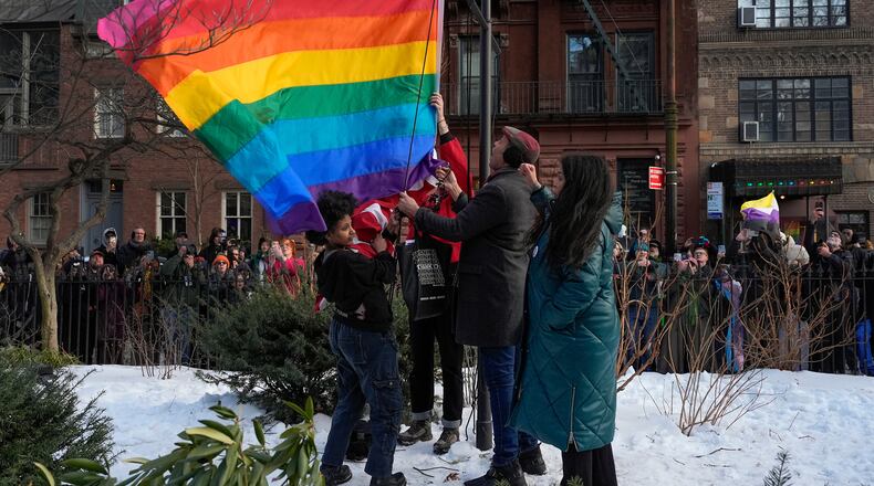 FILE - New York politicians and activists raise a rainbow flag on a pole in Christopher Park across the street from the Stonewall Inn, Thursday, Feb. 12, 2026, in New York, a few days after it was removed by the National Park Service to comply with guidance from the Trump administration. (AP Photo/Yuki Iwamura, File)