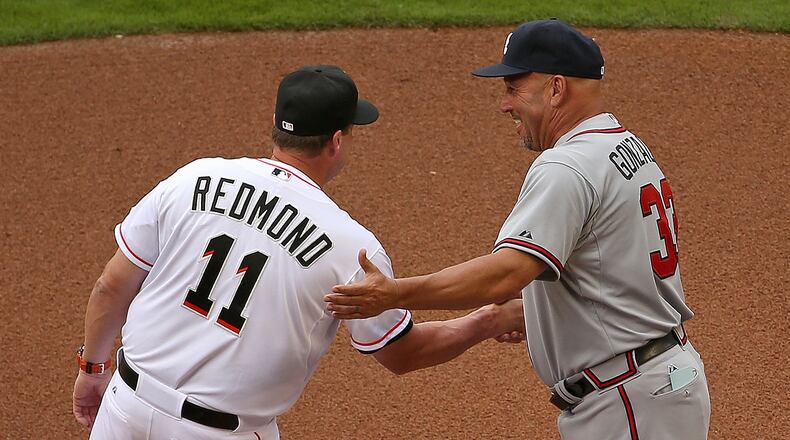 MIAMI, FL - APRIL 06: Mike Redmond #11 of the Miami Marlins and Fredi Gonzalez #33 of the Atlanta Braves talk during Opening Day at Marlins Park on April 6, 2015 in Miami, Florida. (Photo by Mike Ehrmann/Getty Images)