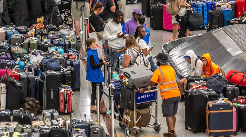 Baggage stored in the Delta Air Lines baggage claim area wait for passengers to claim them on Tuesday, July 23, 2024, amid the disruption caused by a global technology outage that upended the Atlanta-based carrier. (John Spink/AJC)