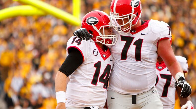 COLUMBIA, MO - OCTOBER 11: Hutson Mason #14 celebrates with John Theus #71 of the Georgia Bulldogs after Hutson Mason scored the first touchdown of the game to put the bulldogs up 13 to o against the Missouri Tigers on October 11, 2014 at Faurot Field/Memorial Stadium in Columbia, Missouri. (Photo by Kyle Rivas/Getty Images) Hutson Mason and John Theus celebrate Mason's 11-yard touchdown run in the second quarter. (Getty Images)