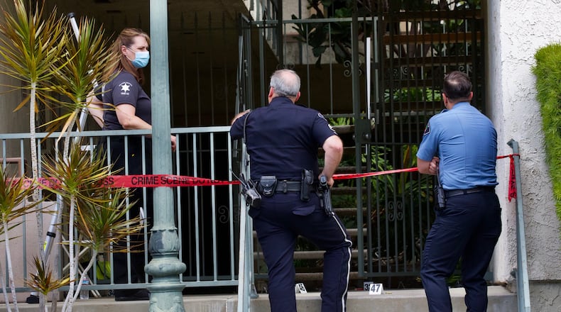 An investigation is underway following a mass shooting in Orange, California, that claimed the lives of four people, including a 9-year-old boy. Evidence markers and shell casings can be seen where 44-year-old Aminadab Gaxiola Gonzalez is suspected of killing four people in the courtyard of the building in the 200 block of West Lincoln Avenue. He was charged Friday with murder and attempted murder. (Irfan Khan/Los Angeles Times/TNS)
