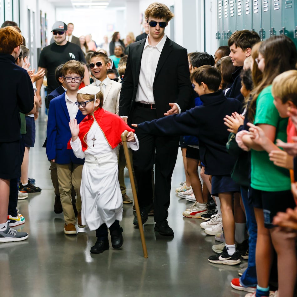 Pope David, also know as second-grader David Levergood, waves to middle-schoolers as he tours the school after being elected as the new pontiff during a mock papal conclave at Pinecrest Academy on May 6, 2025. (Miguel Martinez/AJC)