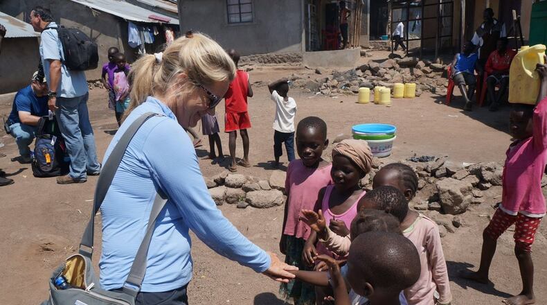 Anne French, director of global mission for the Peachtree Road United Methodist Church, shares a light moment with children on Kenya’s Lake Victoria, where waterborne diseases are major causes of death. The church recently launched a campaign to raise $480,000, enough to purchase and deliver 12,000 UZima filters. To help, text filter to 91999 or make a donation at www.StartWithOneKenya.org. CONTRIBUTED