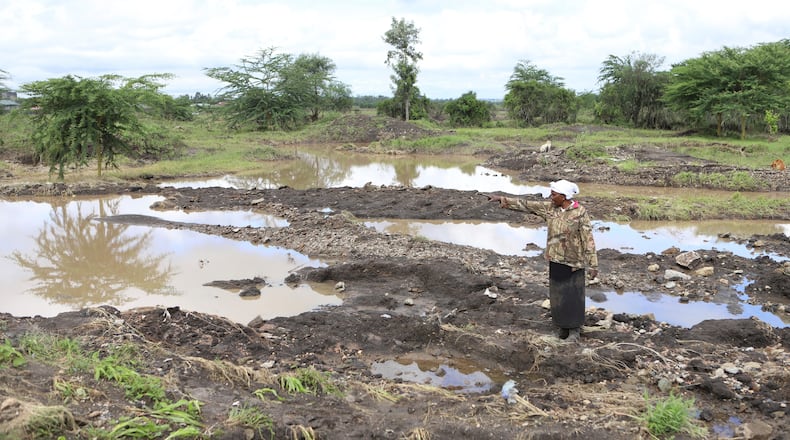 FILE - Martha Waema, stands on her farm after it was submerged by weeks of rainfall in Machakos, Kenya, May 8, 2024. (AP Photo/Andrew Kasuku, File)