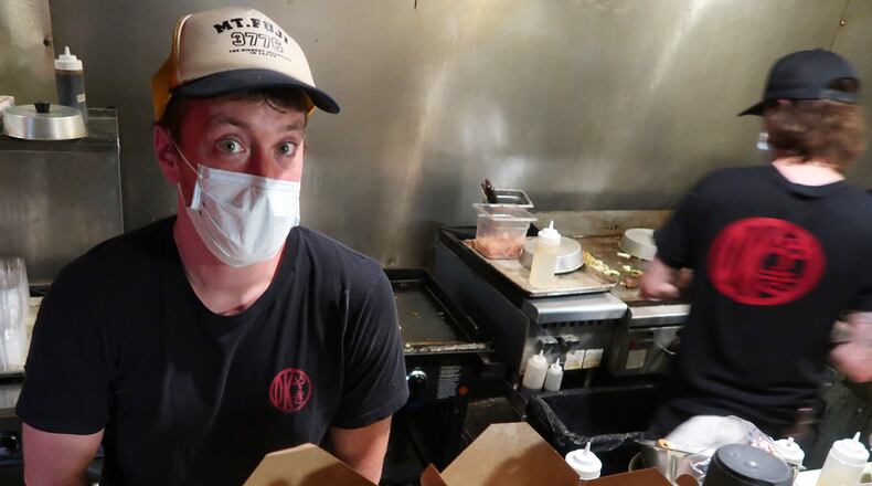 Corban Irby, owner of OK Yaki, prepares meals for takeout at 97 Estoria in Cabbagetown. CONTRIBUTED BY CALEB IRBY
