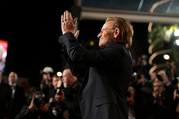 Bono poses for photographers upon arrival at the premiere of the film 'Bono: Stories of Surrender' at the 78th international film festival, Cannes, southern France, Friday, May 16, 2025. (AP Photo/Natacha Pisarenko)