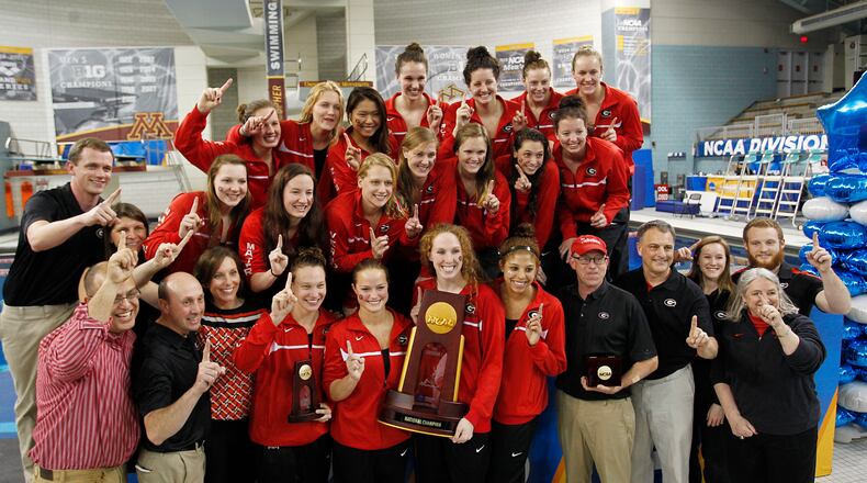 Georgia competitors pose with the championship trophy after winning the NCAA women's swimming and diving championships in Minneapolis, Saturday, March 22, 2014. (AP Photo/Andy Clayton-King)