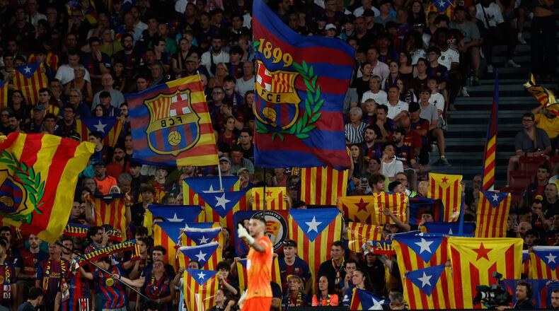 Supporters lift independence flags during a Spanish La Liga soccer match between Barcelona and Athletic in Barcelona, Spain, Thursday, Aug. 27, 2026. (AP Photo/Joan Monfort)