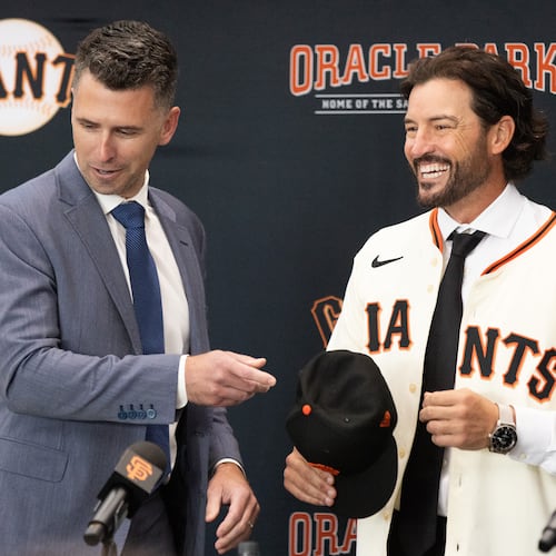 San Francisco Giants President of Baseball Operations Buster Posey, left, welcomes Tony Vitello as the new manager of the San Francisco Giants baseball team on Thursday, Oct. 30, 2025, in San Francisco. (AP Photo/Benjamin Fanjoy)