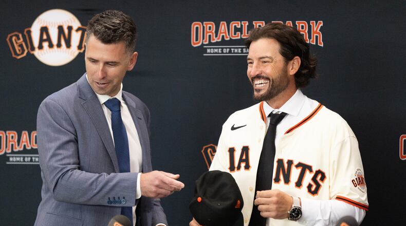 San Francisco Giants President of Baseball Operations Buster Posey, left, welcomes Tony Vitello as the new manager of the San Francisco Giants baseball team on Thursday, Oct. 30, 2025, in San Francisco. (AP Photo/Benjamin Fanjoy)