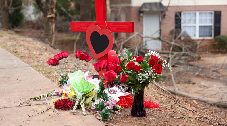 A memorial is set up for University of Georgia football player Devin Willock and UGA football team staff member Chandler LeCroy on Saturday, Jan. 21, 2023, at the site where their vehicle crashed on Barnett Shoals Road in Athens, Ga. Willock and LeCroy died from their injures and two passengers were injured in the Jan. 15, 2023, accident. (Jason Getz/AJC)