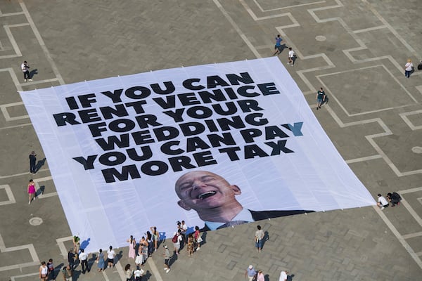 This photo released by Greenpeace shows a large banner against Amazon founder Jeff Bezos' planned wedding, in St. Mark Square, in Venice, Italy Monday, June 23, 2025. (Greenpeace via AP)