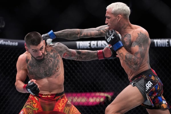 Ilia Topuria, left, fights Charles Oliveira in a lightweight title fight at UFC 317, Saturday, June 28, 2025, in Las Vegas. (AP Photo/John Locher)