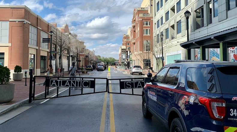 Gunfire between two groups at Atlantic Station left a woman injured Saturday night, according to Atlanta police.