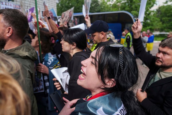Olha Kurtmalaieva shouts to Ukrainian marine soldiers after a POWs exchange between Russia and Ukraine, in Chernyhiv region, Ukraine, Saturday, June 14, 2025. (AP Photo/Evgeniy Maloletka)