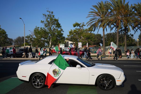 Protesters march along a street Tuesday, June 10, 2025, in Santa Ana, Calif. (AP Photo/Jae C. Hong)