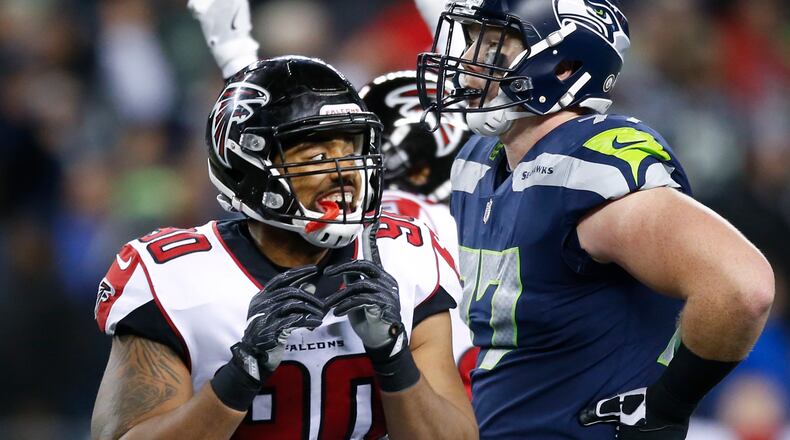 SEATTLE, WA - NOVEMBER 20: Defensive end Derrick Shelby #90 of the Atlanta Falcons and Ethan Pocic #77 of the Seattle Seahawks react as the 52 yard field goal attempt by Blair Walsh #7 to tie the game is no good and the Falcons win at CenturyLink Field on November 20, 2017 in Seattle, Washington. The Atlanta Falcons beat the Seattle Seahawks, 34-31. (Photo by Otto Greule Jr /Getty Images)