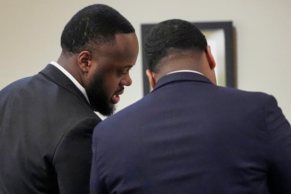 Former Memphis Police Officer Tedarrius Bean, left, one of three former Memphis officers charged with fatally beating Tyre Nichols in 2023, speaks to his attorney during his trial, Wednesday, April 30, 2025, in Memphis, Tenn. (AP Photo/George Walker IV, Pool)