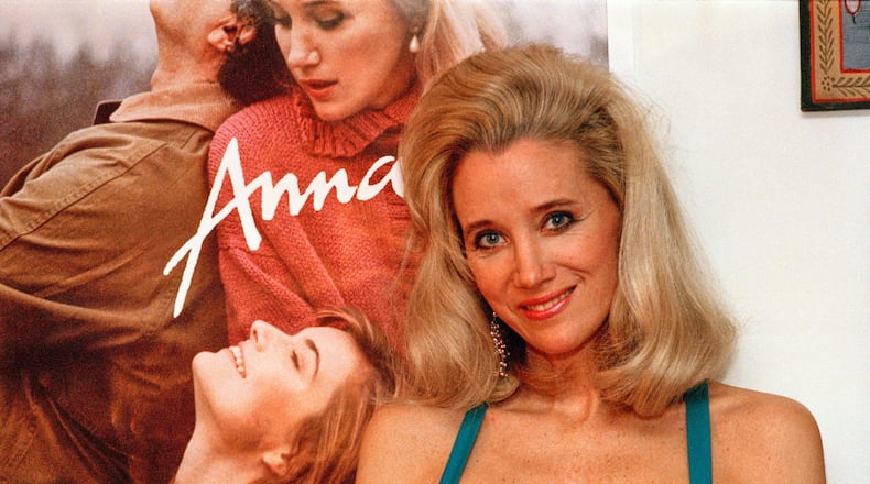 FILE - Sally Kirkland stands next to a poster of her film "Anna" in Los Angeles on Feb. 9, 1988. (AP Photo/Mark Terrill, File)