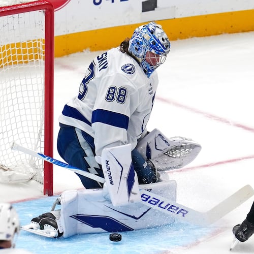 Tampa Bay Lightning goaltender Andrei Vasilevskiy (88) blocks a shot by Pittsburgh Penguins' Rickard Rakell during the first period of an NHL hockey game in Pittsburgh, Tuesday, Jan. 13, 2026. (AP Photo/Gene J. Puskar)