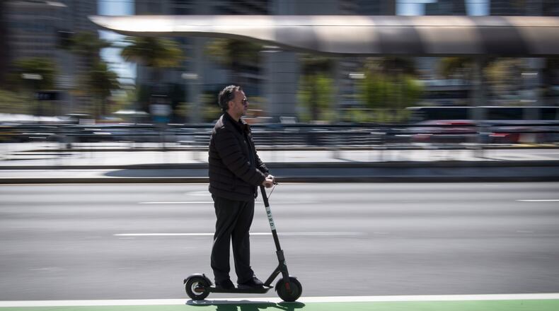 A person rides a Bird Rides shared electric scooter on the Embarcadero in San Francisco, California, on April 13, 2018. MUST CREDIT: Bloomberg photo by David Paul Morris Photo by: David Paul Morris - Bloomberg
