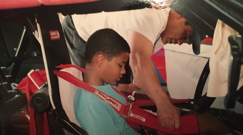 A young Eason Fromayan tests out a race-car cockpit. (Courtesy Fromayan family)
