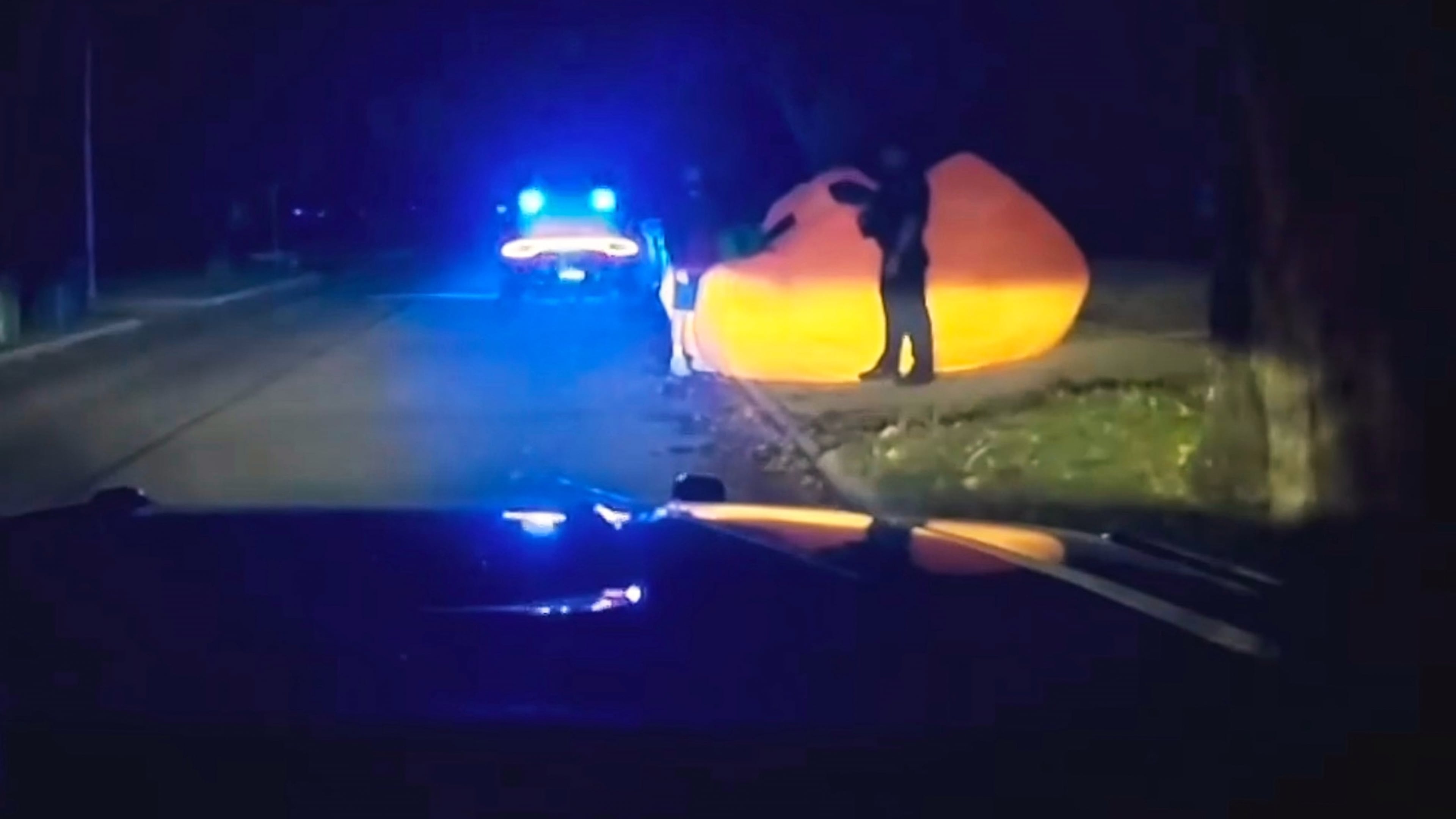 This image made from a Parma Heights Police Department body camera video shows a police officer approaching a runaway inflatable pumpkin on Tuesday, Oct. 7, 2025. (Parma Heights Police Department via AP)